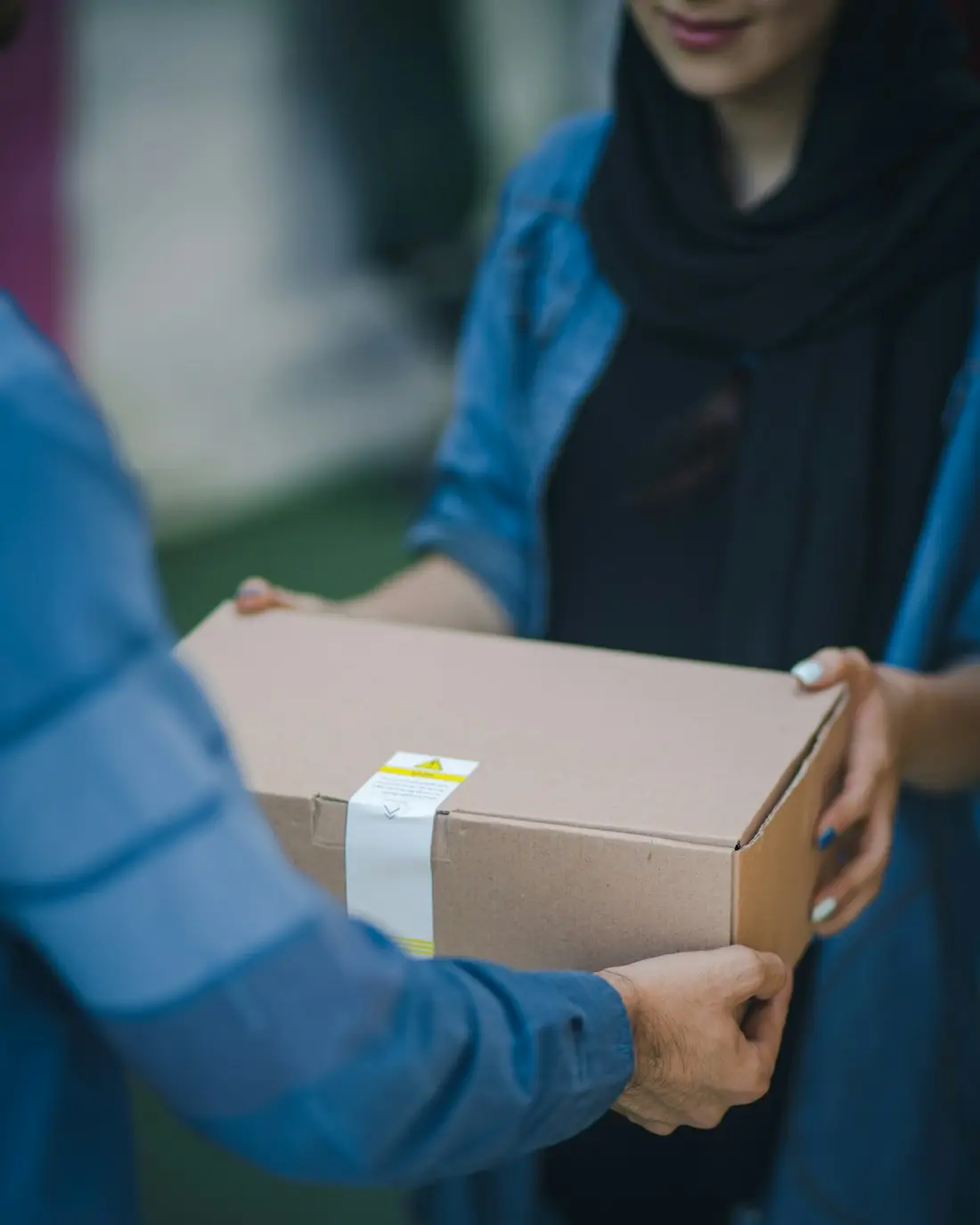 Stedfasts courier handing a parcel to a customer